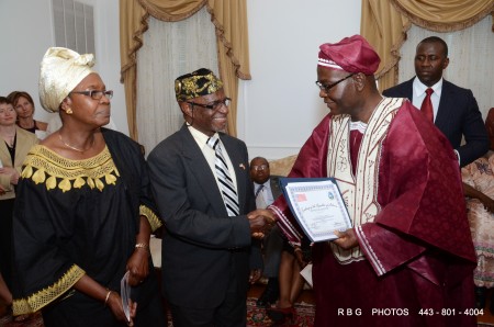 The Rev. Dr. Edwin Lloyd receiving certificate of appreciation from Amb. Sulunteh