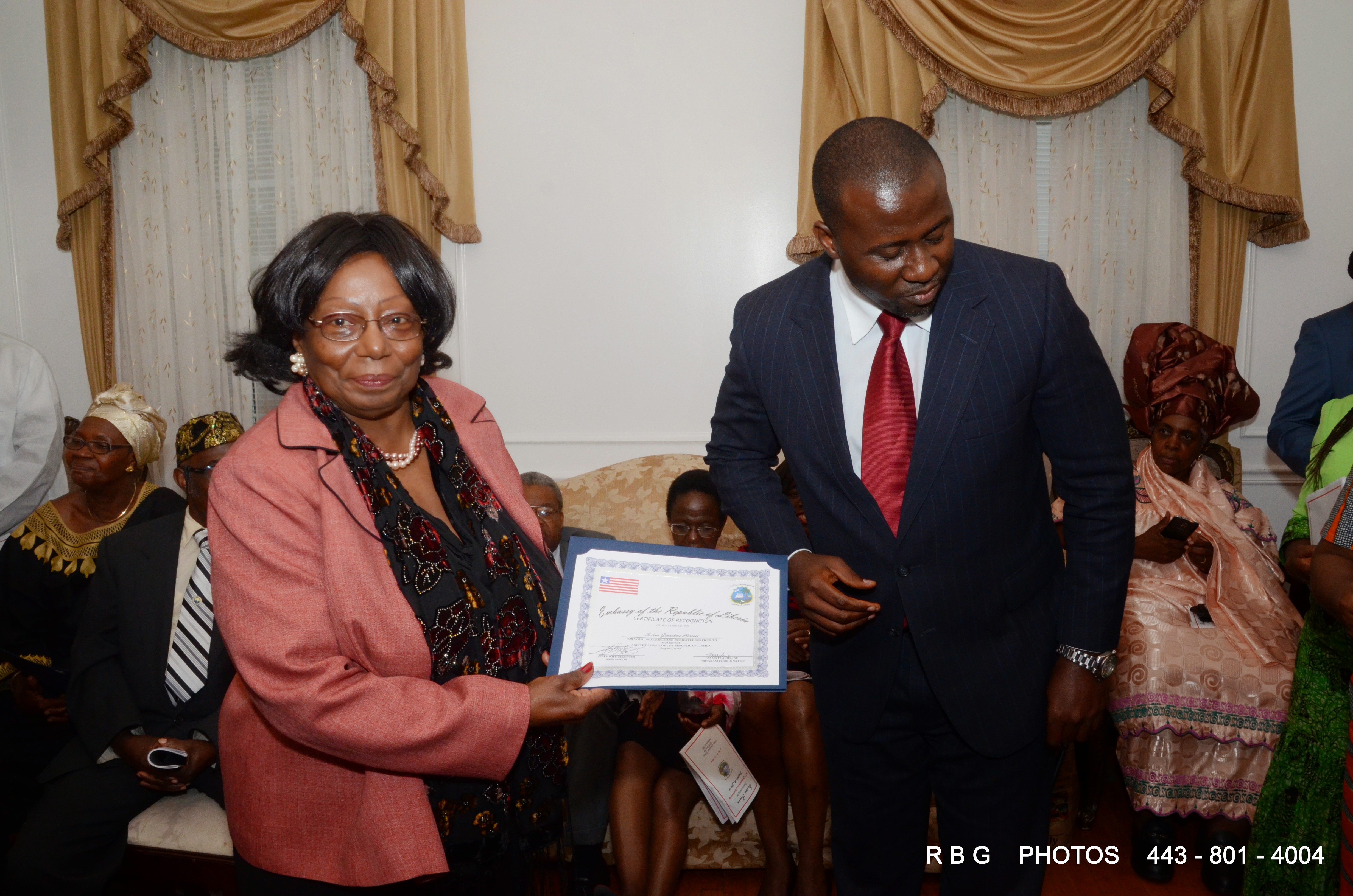 Deputy Foreign Elias Shoniyin presents certificate to Mrs. Selena Horace-Hoffman