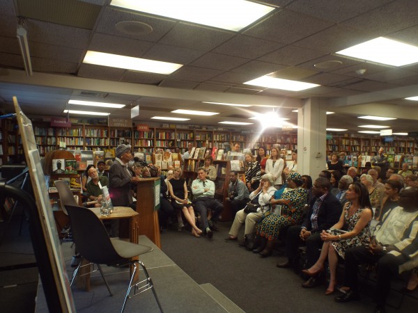 President Ellen Johnson Sirleaf, left, speaking at the book signing ceremony. Seated front row, right to left include Ambassador Jeremiah Sulunteh, author Riva Levison